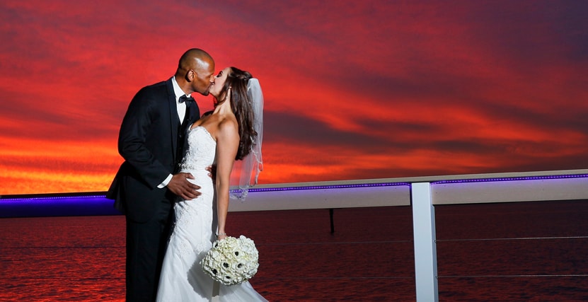Couple kissing on Sunset Pier at Bon Appetit Restaurant in Dunedin, FL