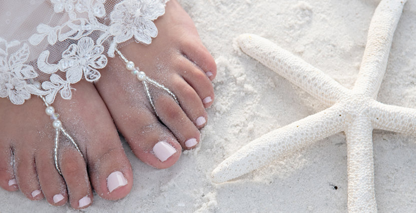 Wedding toes and Starfish in sand at Honeymoon Island by Shannon Livingston Photography